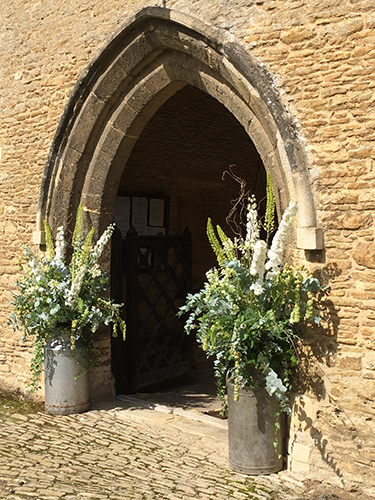 Wedding flowers decorating the church porch